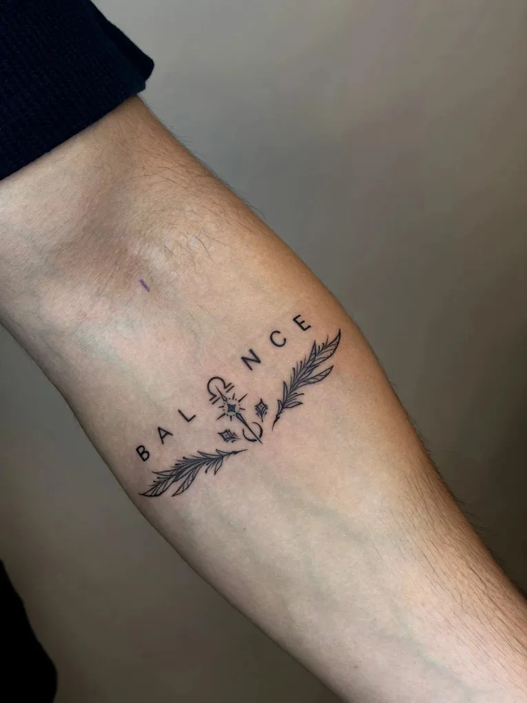 Balance tattoo with feathers